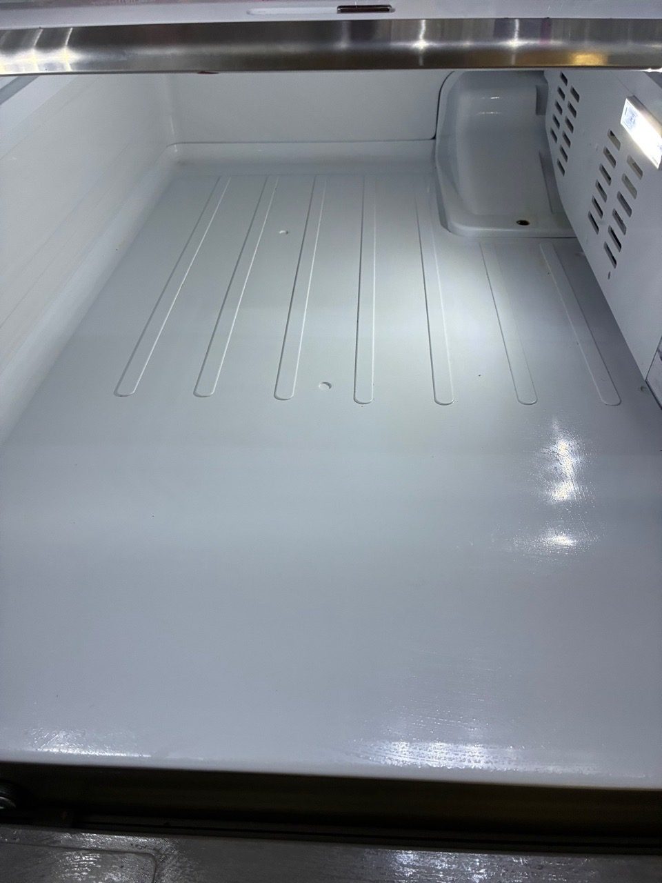 The same refrigerator emptied and wiped spotless