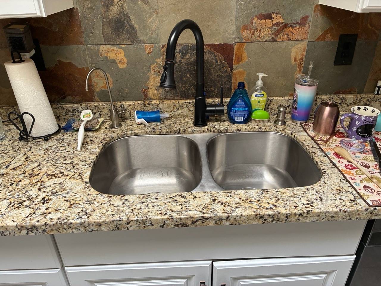 Polished stainless kitchen sink after a residential cleaning