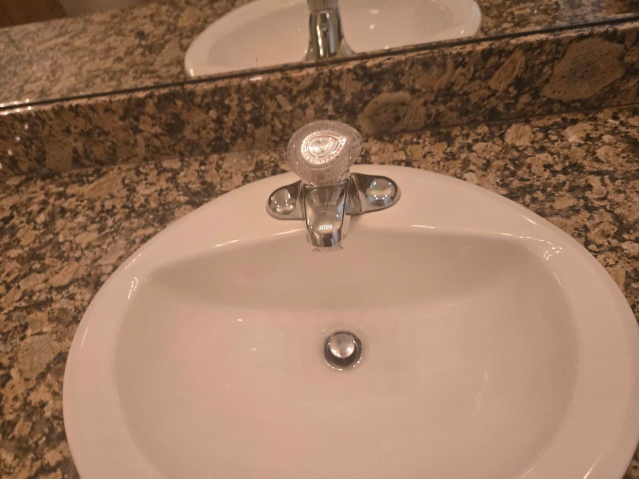 Close detail of a clean bathroom sink and polished faucet after a deep clean