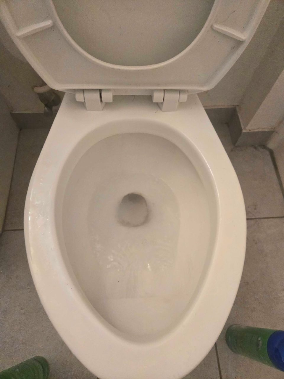 The same toilet scrubbed clean and sanitized after a deep clean